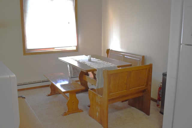 carpeted dining area featuring a baseboard radiator