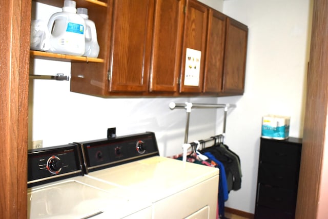 washroom featuring washer and clothes dryer and cabinets