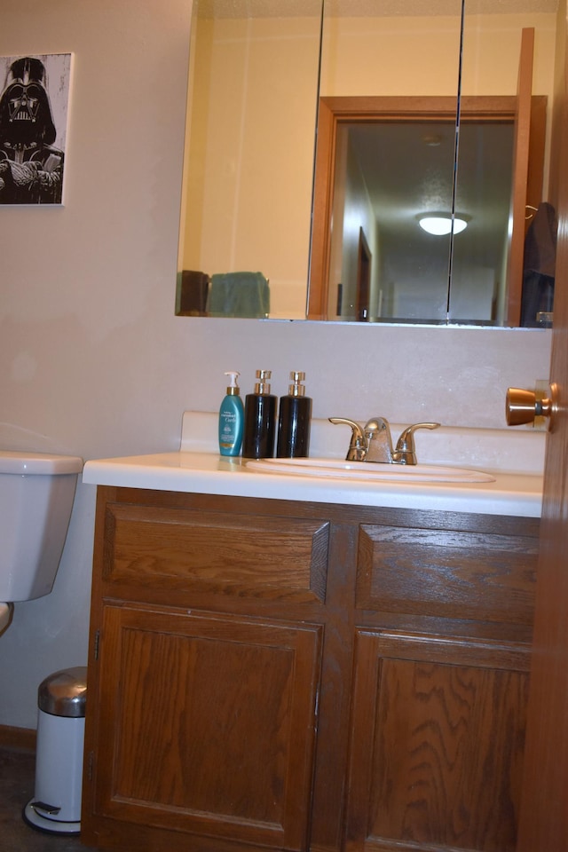 bathroom featuring vanity and toilet