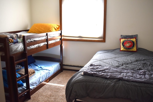 bedroom with a baseboard radiator and carpet