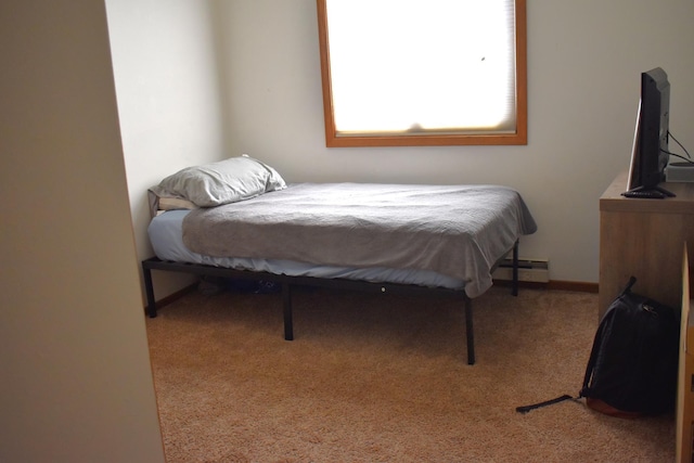 carpeted bedroom with a baseboard radiator