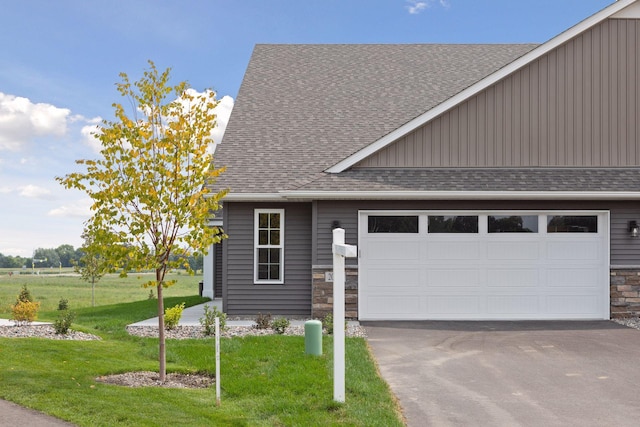 view of front of house with a garage and a front lawn