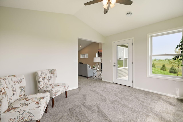 living area featuring carpet, lofted ceiling, and ceiling fan