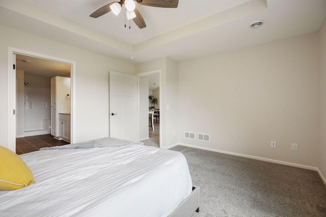 carpeted bedroom featuring ceiling fan and ensuite bathroom