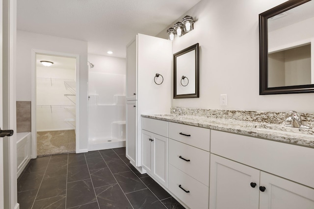 20092 Fitzgerald Trl N, Forest Lake, MN 55025 - bathroom featuring marble look tile flooring, a shower, a spacious closet, double vanity, and recessed lighting