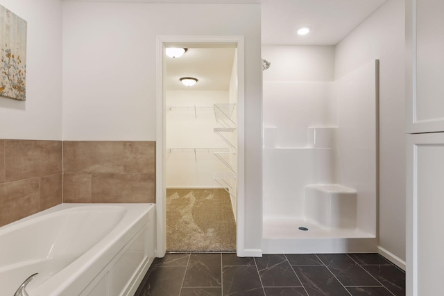 20092 Fitzgerald Trl N, Forest Lake, MN 55025 - bathroom with walk in shower, a spacious closet, marble finish flooring, a bath, and baseboards