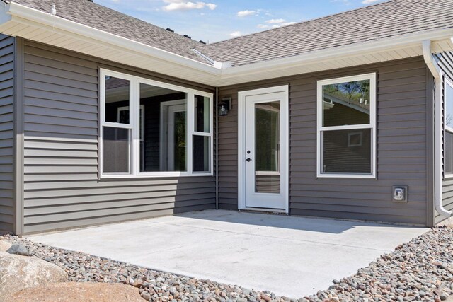 20092 Fitzgerald Trl N, Forest Lake, MN 55025 - doorway to property with a patio and a shingled roof