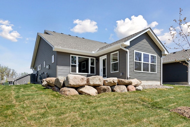 20092 Fitzgerald Trl N, Forest Lake, MN 55025 - back of house with a yard, central air condition unit, and a shingled roof