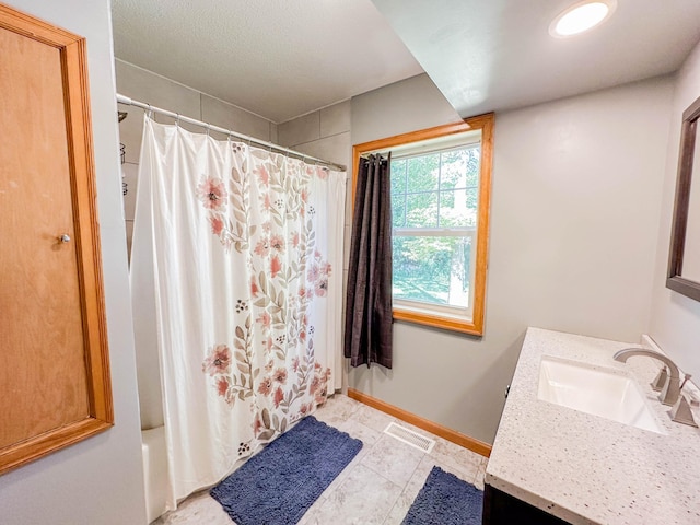 bathroom with shower / tub combo, vanity, and tile patterned floors