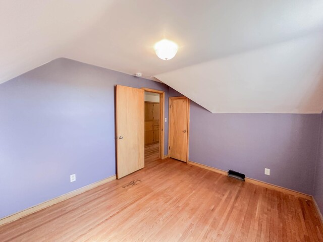 bonus room featuring light hardwood / wood-style floors and lofted ceiling