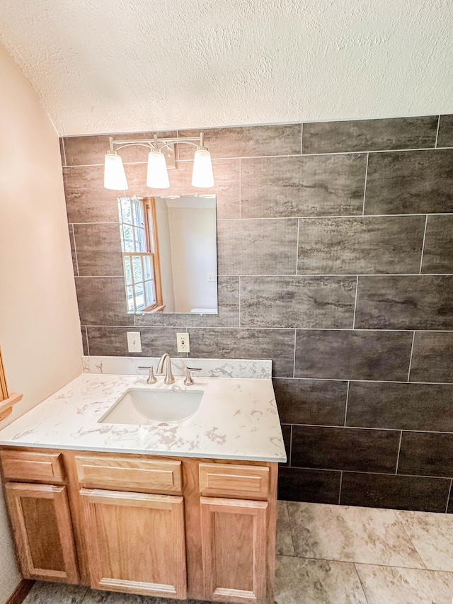 bathroom with a textured ceiling and vanity