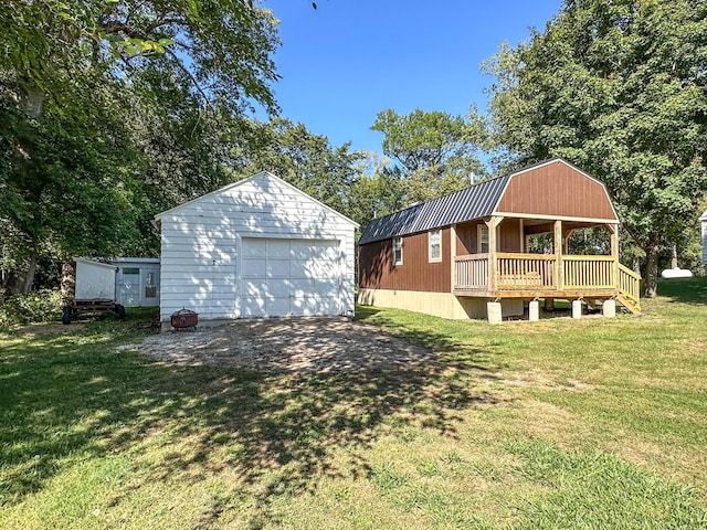 view of yard featuring a garage and an outbuilding