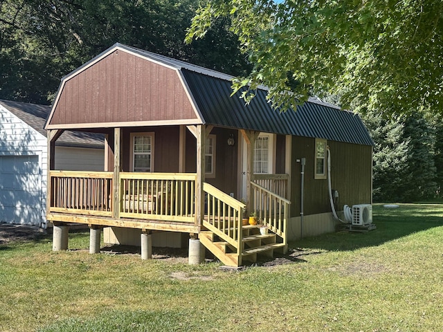 exterior space with ac unit, a porch, and a yard