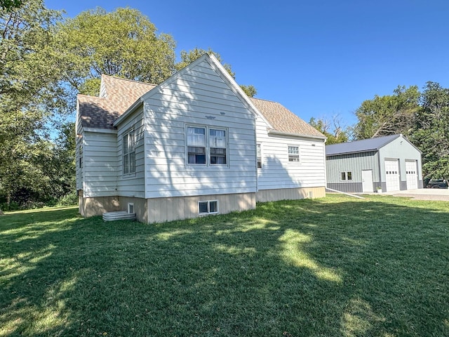 exterior space with a lawn, an outbuilding, and a garage