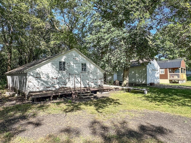 exterior space featuring a wooden deck and a front lawn