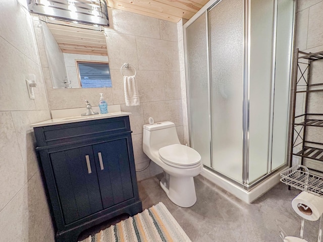 bathroom with vanity, concrete flooring, walk in shower, tile walls, and toilet