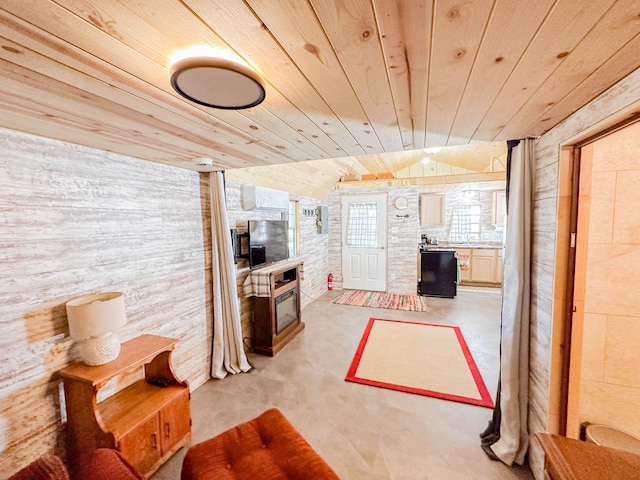 living room featuring wooden ceiling, wood walls, and vaulted ceiling