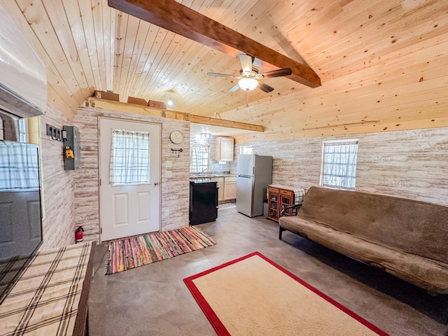 unfurnished living room featuring lofted ceiling with beams, ceiling fan, wooden ceiling, and a healthy amount of sunlight