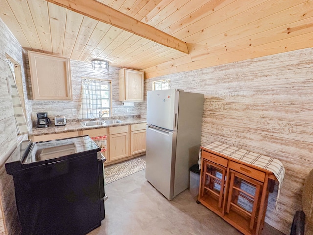 kitchen featuring wood walls, white fridge, wooden ceiling, light brown cabinetry, and sink