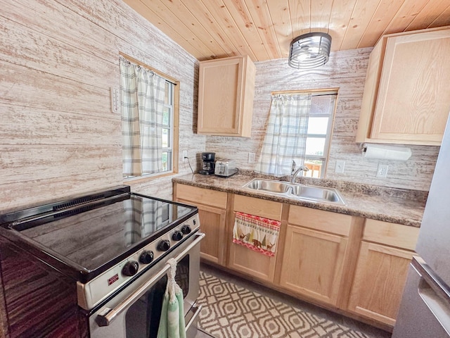 kitchen with light brown cabinetry, stainless steel range oven, wood ceiling, and sink