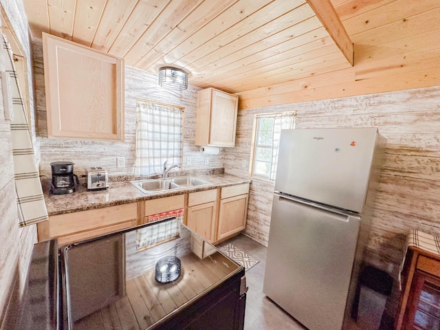 kitchen featuring wood ceiling, light brown cabinetry, sink, and stainless steel refrigerator