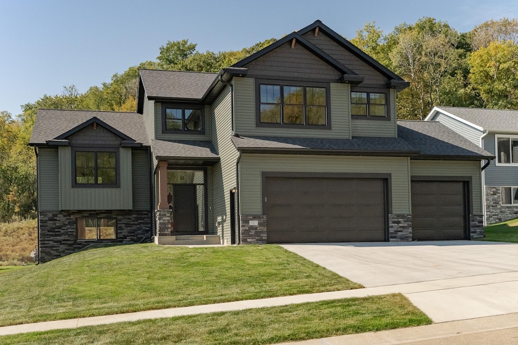 craftsman house featuring a garage and a front yard