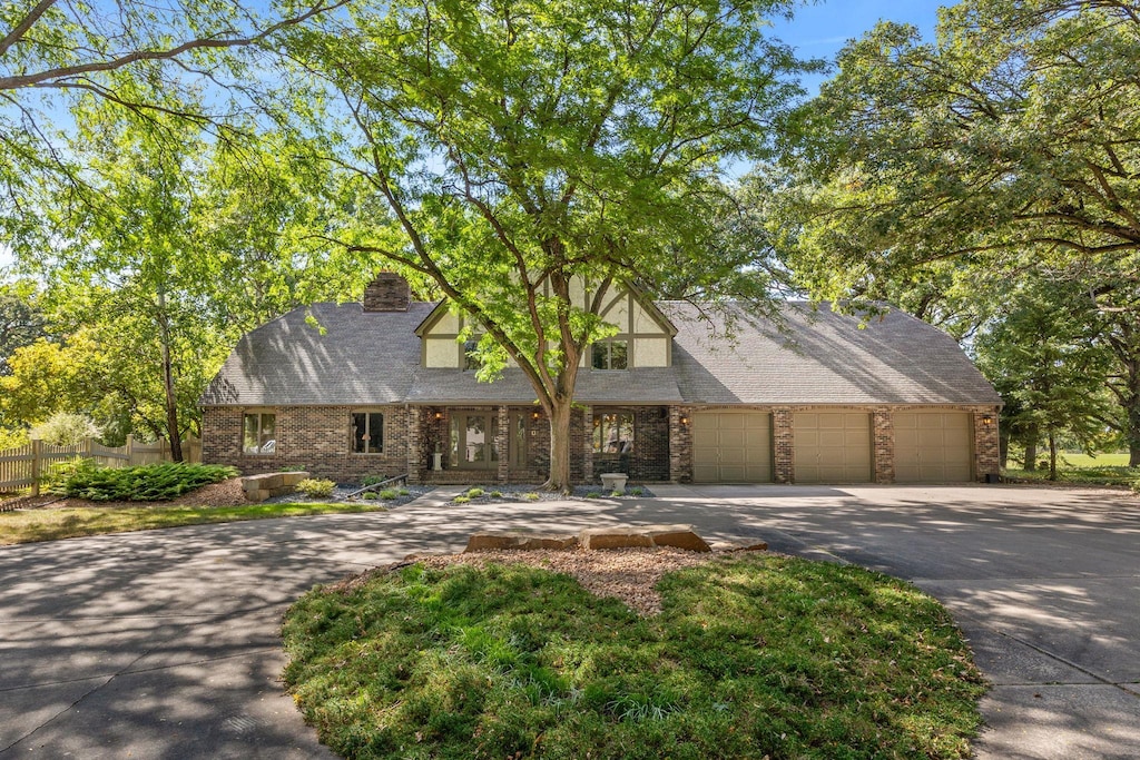 tudor house featuring a garage