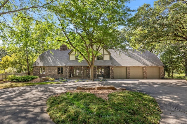 tudor house featuring a garage