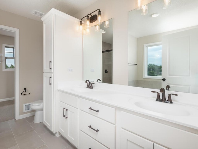 bathroom with vanity, toilet, walk in shower, and a wealth of natural light