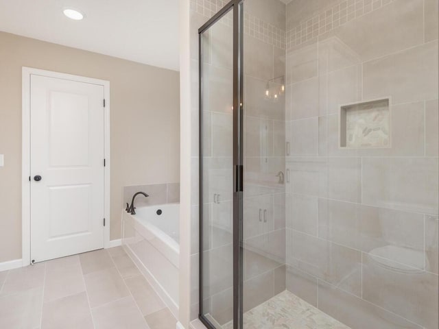 bathroom with tile patterned floors and independent shower and bath