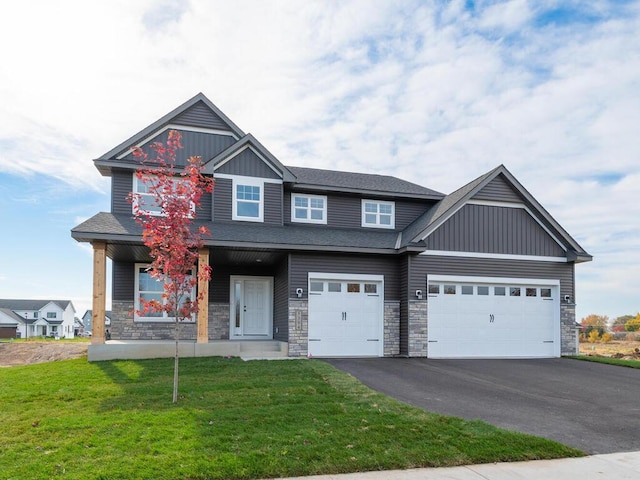 craftsman-style house featuring a front yard, a porch, and a garage