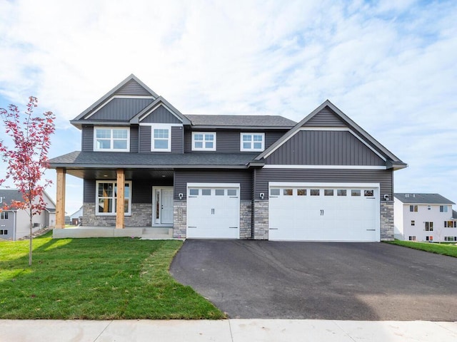 craftsman inspired home featuring a porch, a front yard, and a garage