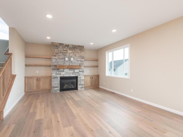 unfurnished living room featuring a fireplace and light wood-type flooring