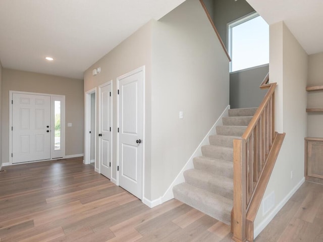 foyer entrance with light hardwood / wood-style flooring