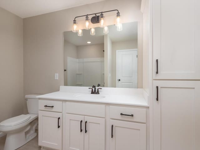 bathroom with vanity, toilet, and walk in shower