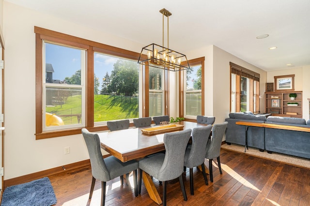 dining space featuring a notable chandelier and dark hardwood / wood-style flooring