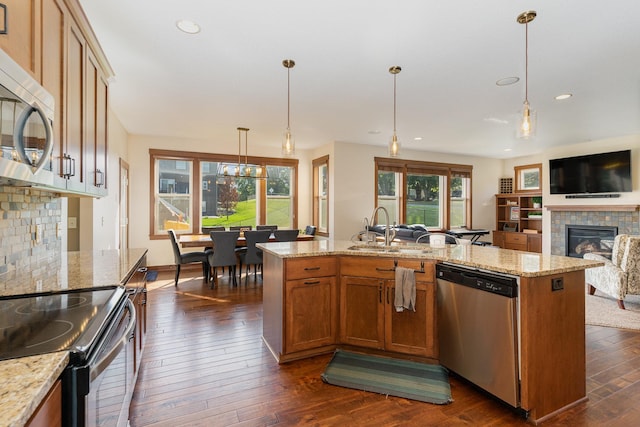 kitchen with hanging light fixtures, appliances with stainless steel finishes, plenty of natural light, and sink