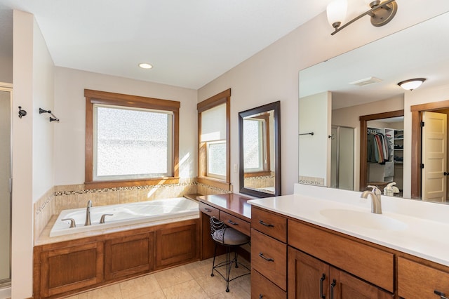 bathroom with tile patterned floors, vanity, and independent shower and bath