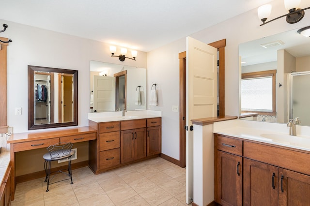 bathroom featuring vanity and a shower with shower door