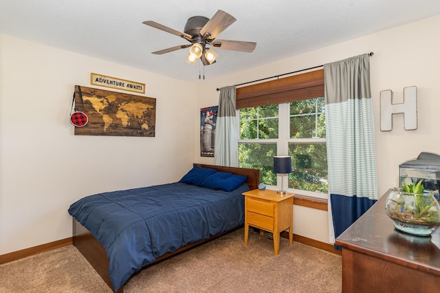 bedroom featuring light colored carpet and ceiling fan