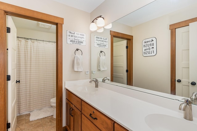 bathroom featuring curtained shower, vanity, toilet, and tile patterned floors