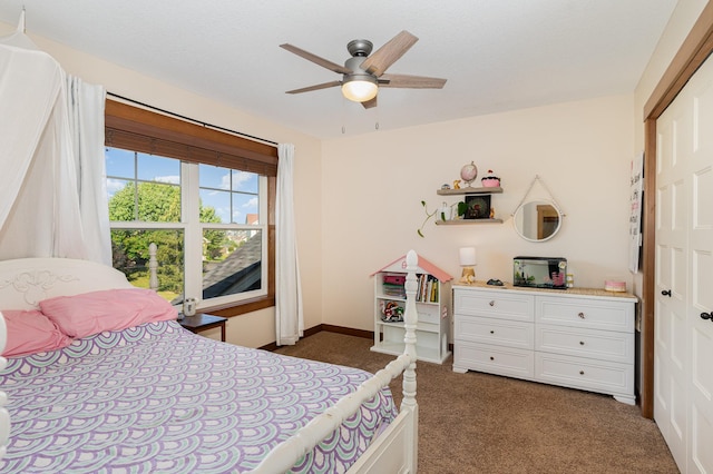 carpeted bedroom with ceiling fan and a closet