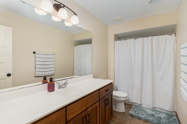 bathroom featuring tile patterned flooring, vanity, and toilet