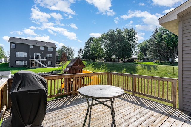 wooden terrace with a yard and grilling area