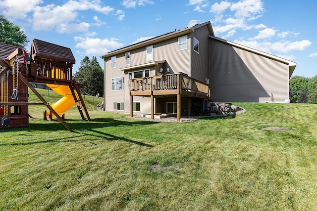 back of house with a yard and a playground