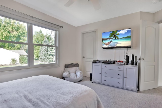 bedroom with light carpet and ceiling fan