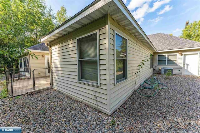 view of side of home featuring central AC unit