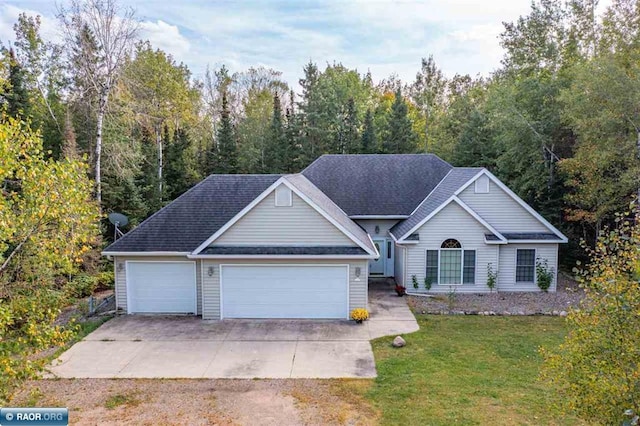 view of front of home featuring a front yard and a garage