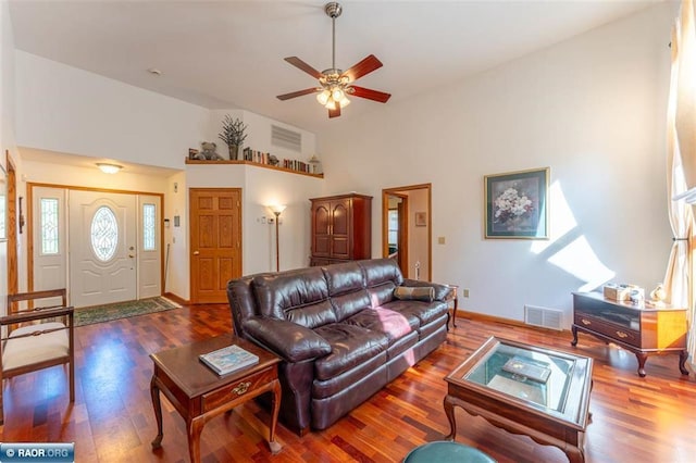 living room featuring ceiling fan, dark wood-type flooring, and high vaulted ceiling