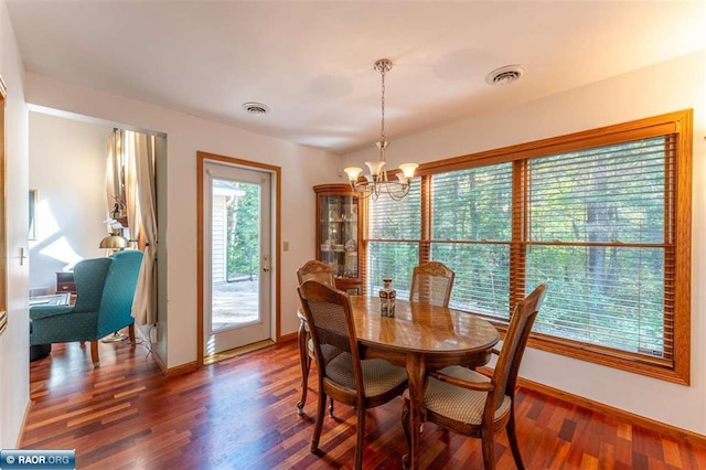 dining room with a notable chandelier and dark hardwood / wood-style floors